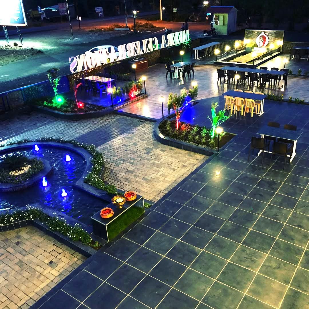 Meera Garden restaurant — open-air tables lit up at night