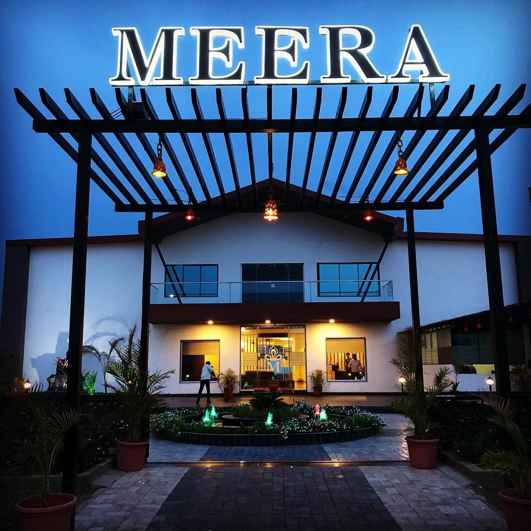The entrance to Meera Celebration lit up at night