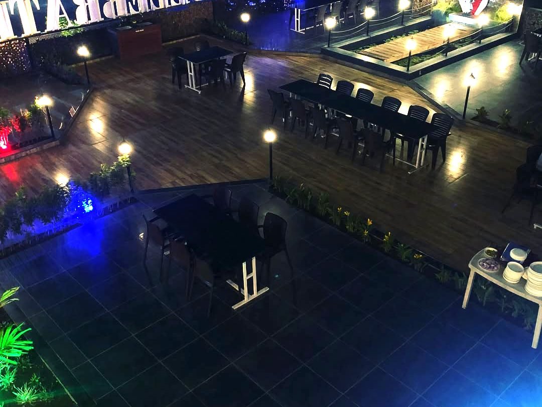 Meera Garden restaurant — open-air seating lit up at night