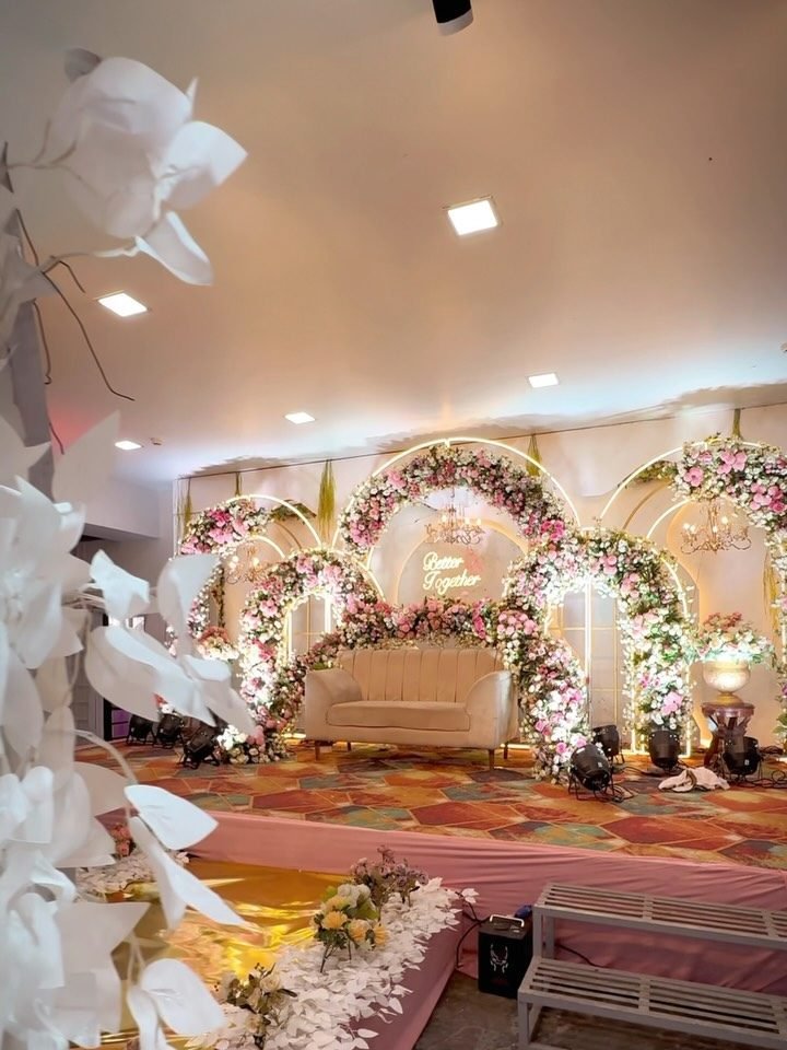 The banquet hall at Meera Celebration dressed with a floral reception stage