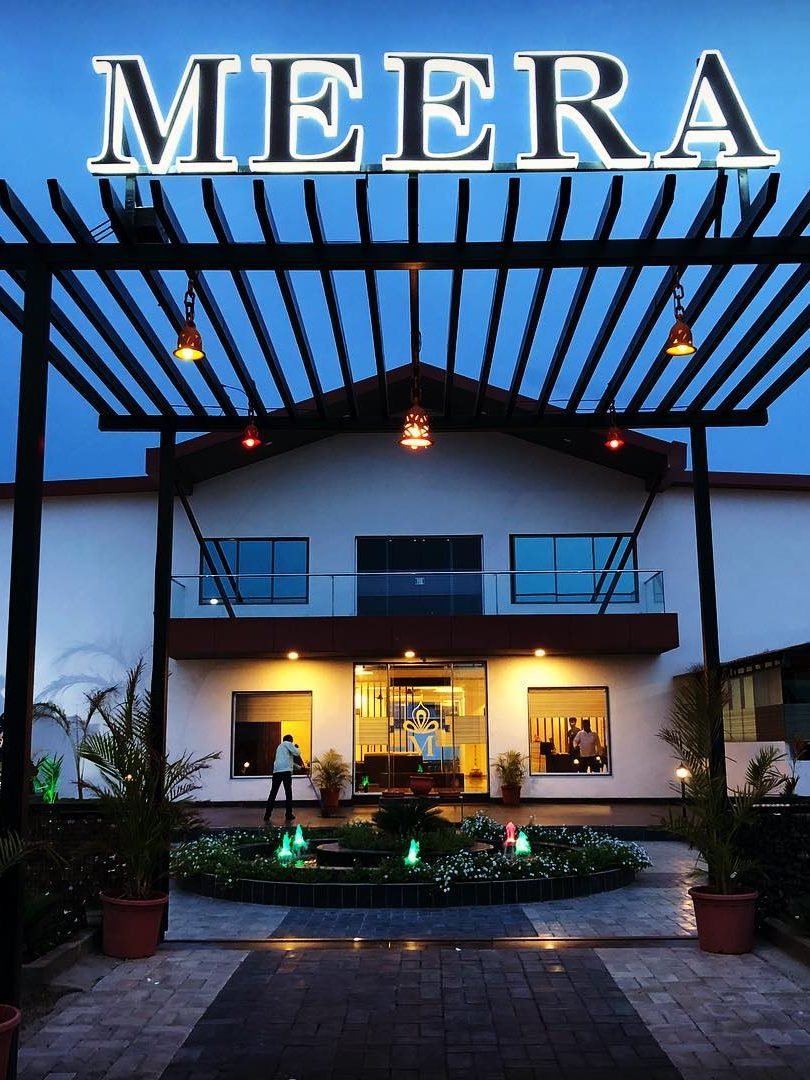 The entrance to Meera Celebration lit up at night